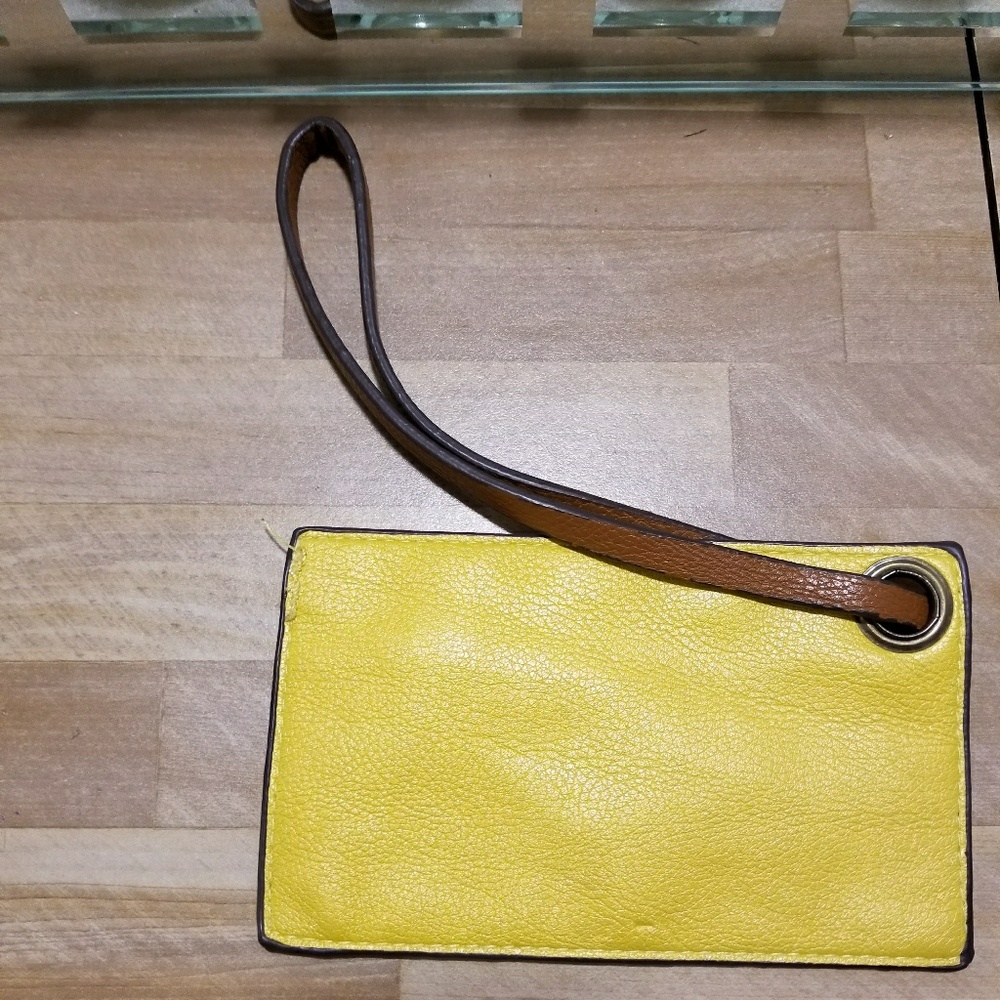 Yellow wristlet w brown handle used